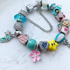 Welcome to buttrescharms! We are newly opened shop and offering the best price for our unique custom bracelets! ❤️This listing is for one Summer them flowers beach theme full charms bracelet shown above. All the charms and beads on the bracelet are compatible with Pandora bracelet. ❤️ What makes our bracelets unique: Our bracelets are designed to meet everyone's needs, it includes different types of beads and charms from our newest collection, 17 of our most popular charms in total (including on Playful Pink Jewelry With Removable Charms, Colorful Bracelet Jewelry For Birthday, Pink Charm Bangle Bracelets, Pink Dangling Charms For Friendship, Playful Pink Charm Bracelets, Playful White Bracelet With Charms, Whimsical Beaded Bracelets With Charms, Whimsical Pink Charm Bracelet For Birthday, Playful White Charm Bracelet