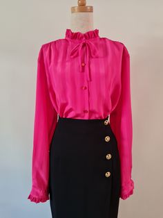 Right On by Remona Melbourne, Fuschia pink self stripe long sleeved jacquard blouse with ruffles at neckline and cuff. Button through with button cuff and simple rouleau mock bow at neckline.  She's marked a fabulous plus size 20, but see measurements below to check on actual sizing (closer to an 18). Fuschia Pink  100% Polyester Very Good Condition Body Length from HPS -  71cm  Sleeve length from CB Neck - 79cm   Shoulder width - 45cm  Bust - 62cm  Hip - 62cm Follow us on Instagram @packratt_vi Chic Long Sleeve Pink Blouse, Chic Pink Long Sleeve Blouse, Pink Long Sleeve Office Blouse, Elegant Pink Tie Neck Top, Elegant Long Sleeve Pink Blouse, Elegant Pink Long Sleeve Blouse, Pink Tie Neck Top For Work, Pink Formal Blouse For Fall, Formal Pink Blouse For Fall