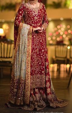 a woman in a red and gold bridal gown