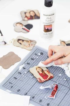 a person cutting out pictures with scissors on a piece of paper next to other cut outs