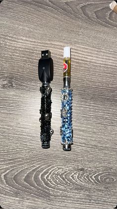 two different types of lighters on a wooden surface with one being used as an object