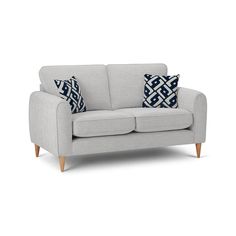 a grey couch with blue and white pillows on top of it's back legs