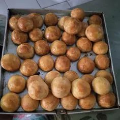 there are many rolls in the box on the table, ready to be baked and eaten