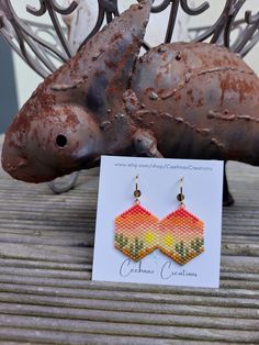 a pair of earrings sitting on top of a wooden table