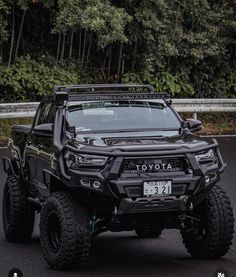 a black toyota truck is parked on the street