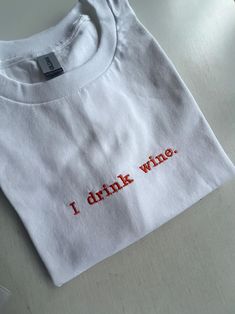 I Drink Wine Embroidered T-shirt, Monogram, Funny T-shirt, Unisex, SHIPPING INFO: FREE UK DELIVERY are sent as 1st Class (1-2 Working days) UK EXPRESS (Next day delivery) this is an extra cost at checkout Europe sent as International Tracked (Expected 3-5 working days) Worldwide sent as International Tracked (Expected 5-7 working days) EMBROIDERY THREAD: POLYESTER T-SHIRT: 100% COTTON (WHITE 170 GSM) (OTHER COLS 180 GSM) SWEATSHIRT: 80% COTTON, 20% POLYESTER (WHITE + HEATHER GREY 260 GSM) (OTHER Graphic Tee With Letter Embroidery Crew Neck, Graphic Tee With Letter Embroidery, White Crew Neck Shirt With Embroidered Text, White Embroidered Text Crew Neck Shirt, Red Embroidered Crew Neck T-shirt, Red Short Sleeve T-shirt With Embroidered Text, White Embroidered Crew Neck T-shirt, Embroidered Crew Neck Graphic Tee, White Heather