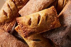 several pastries stacked on top of each other with holes in the middle and powdered sugar covering them