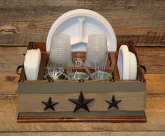 a wooden box filled with dishes and cups