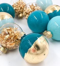 several blue and gold ornaments on a white surface