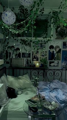 a bed room with a neatly made bed and lots of pictures on the wall behind it