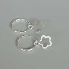 A PAIR of sterling silver hoops. Comes with a detachable cut out flower charm. The charm is multipurpose and can be used with a neck or bracelet chain too. Dimension: Hoop- 15 x 1.5 mm Charm: 10 x 12 mm Drop length- 23 mm These earrings are made of 925 hypoallergenic sterling silver and plastic. Please note this price is for ONE PAIR. All my pieces are sent in a gift box. I can include a personal message from you if needed You are welcome to contact me at... bhavnakwintra1956@gmail.com For more Small Hoop Jewelry With Flower Charm For Everyday, Small Hoop Jewelry With Flower Charm For Gifts, Everyday Small Hoop Jewelry With Flower Charm, Nickel Free White Sterling Silver Huggie Earrings, Nickel-free White Sterling Silver Huggie Earrings, Flower Charm Huggie Earrings As Gift, Gift Huggie Hoop Earrings With Flower Charm, Flower Charm Hoop Earrings Gift, Huggie Jewelry With Flower Charm For Gift