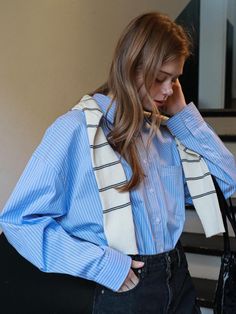 This product is an oversized Eden stripe shirt that effortlessly combines comfort with a relaxed aesthetic. Its exaggerated dimensions bring a contemporary edge to the classic striped shirt. Ideal for casual wear or a laid-back office environment, this piece is a versatile addition to any wardrobe. - This shirt offers a loose, airy fit that doesn't compromise on style, making it a staple for comfort-driven fashion.- Constructed with a durable yet soft fabric, it's designed to withstand regular wear while maintaining its crisp appearance.- Features a classic button-down design with a pointed collar and adjustable cuffs to suit personal style and comfort needs.- The shirt's back yoke is reinforced for added durability, and its hem is slightly longer in the back for a modern, asymmetrica Casual Shirt With Vertical Stripes For Office, Classic Oversized Shirt With Striped Collar, Striped Relaxed Fit Shirt For Office, Trendy Striped Office Shirt, Oversized Vertical Stripes Blouse For Work, Striped Shirt For Everyday In Fall, Striped Shirt For Everyday Fall Wear, Oversized Top With Striped Collar For Work, Everyday Striped Shirt For Fall