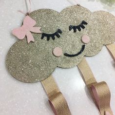 a pair of hair clips made to look like clouds with eyes and eyelashes on them