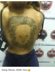 a woman with a lion tattoo on her back