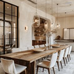 a large wooden table surrounded by white chairs