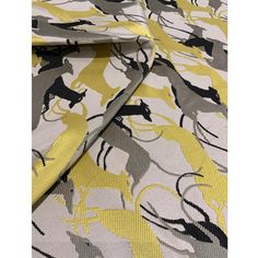 a yellow and grey fabric with horses on it