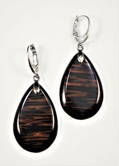 The earrings are one of a kind and handmade from Black Palm wood and have very smooth and brilliant cut  surface. Lever backs are Rhodium plated. Care instructions: Avoid direct contact with perfumes, alcohol, water and other solvents that may damage wood finish. Wipe jewelry with soft dry cloth. Brown Teardrop Earrings For Formal Occasions, Formal Brown Teardrop Earrings, Elegant Brown Pierced Teardrop Earrings, Elegant Brown Teardrop Pierced Earrings, Modern Brown Earrings For Formal Occasions, Brown Teardrop Wood Jewelry, Elegant Brown Wooden Jewelry, Palm Wood, Wood Earrings