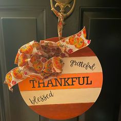 an orange and white sign hanging from the front door of a house that says grateful, grateful, grateful