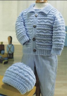 a baby's blue knitted outfit and hat