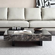 a marble coffee table sitting in front of a couch