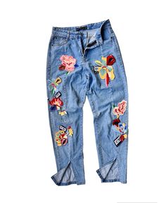 "Description: Elevate your style with these pre-owned vintage jeans featuring delicate flower embroidery and chic patched appliqués, all complemented by a trendy split hem. Each stitch captures the essence of the past, offering a unique blend of nostalgia and contemporary fashion. Embrace sustainable and distinctive style by adding this one-of-a-kind piece to your collection. Details: - Unique patchwork and applique. - Authentic blue jeans crafted from finest materials. - Button-fly and zip-up closure. - Straight leg.  - Split hem.  Size: Waist: 28 - 29\" (Round) Hips: 36\" (Round) Length: 38\" Tight: 22\" (Round) Leg opening: 12\" (Round) Pants / Shirts sizes can vary between brands and regions. So, please have a look at actual measurements above before making the purchase decision. Kindl Medium Wash Jeans With Patches For Spring, Spring Jeans With Patches In Medium Wash, Spring Medium Wash Jeans With Patches, Spring Denim Bottoms With Patches, Denim Blue Jeans With Patches For Spring, Spring Denim Blue Jeans With Patches, Blue Patched Jeans For Spring, Spring Straight Leg Jeans With Patches, Spring Blue Jeans With Patches