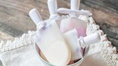 two soap bars in a bowl on a doily