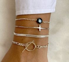 Make a statement with our stunning handmade silver bracelets. Crafted from the highest quality Sterling Silver 925, each piece is unique and eye-catching. Choose from our collection of four distinct designs, including an Evil Eye bracelet, an adjustable bangle with a Cross at the center, a chic chain bracelet, and a modern circle bracelet. Perfect for any occasion, our bracelets are the ultimate addition to your jewelry collection. Shop now and add a touch of elegance to your look. 👉  My Women Nickel-free Sterling Silver Trendy Bracelets, Trendy Nickel-free Sterling Silver Bracelets, Sterling Silver Stackable Chain Bracelet, Trendy Hypoallergenic Sterling Silver Bracelets, Silver Stackable Chain Bracelet As A Gift, Silver Stackable Chain Bracelet Gift, Trendy Sterling Silver Bracelet As Gift, Handmade Elegant Sterling Silver Chain Bracelet, Minimalist Stackable Silver Chain Bracelet