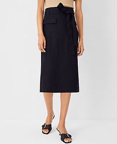 Elevate your wardrobe with the Ann Taylor Tie Waist Cargo Pencil Skirt, a blend of sophistication and practicality. This skirt is designed to cater to the modern woman's needs, featuring a sleek black color that pairs effortlessly with any top.

- **Size**: 14 (Regular)
- **Color**: Black
- **Material**: Shell: 67% Lyocell, 18% Linen, 15% Viscose; Lining: 100% Polyester
- **Gender**: Female
- **Length**: 28 inches long
- **Features**: Front flap cargo pockets, self-tie belt, belt loops, hidden b Black Cargo Skirt For Work, Utility Relaxed Skirt For Work, Spring Workwear Belted Cargo Skirt, Spring Utility Belted Cargo Skirt, Black Cargo Skirt For Spring Workwear, Spring Workwear Pencil Cargo Skirt, Fall Workwear Pencil Skirt With Pockets, Utility Cargo Skirt For Summer Workwear, Spring Utility Skirt For Workwear