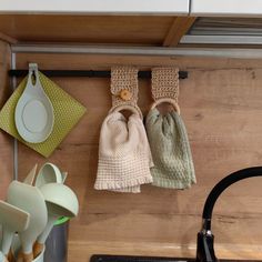 kitchen utensils hanging from hooks on the wall