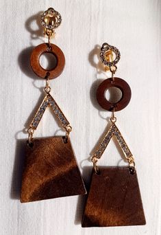 Very natural and classy style  All wood and nice size  Very lightweight  These hang about 3.5 inches  brown wood and Gold and Rhinestone accents and clip on closure  One of kind piece These are a great addition to any unique wardrobe Brown Wooden Earrings For Pierced Ears, Elegant Brown Wooden Jewelry, Brown Wooden Bead Drop Earrings, Brown Wooden Drop Earrings, Brown Wood Drop Earrings, Brown Wooden Dangle Jewelry, Unique Wardrobe, Wood And Gold, Bamboo Earrings