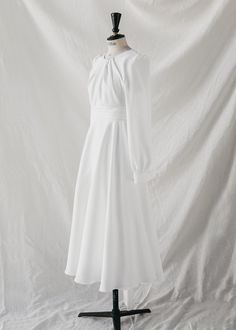 Wedding dress made UPON REQUEST (*) from the Ready to Love collection.



Wedding dress made to order.

Long sleeves with covered cuffs and buttons.

Draped sash that frames the waist that becomes a bow at the back.

Neck to the box.

Skirt with a lot of flight.

Invisible zipper closure on the back.

 Draped on the chest.

Made in white crepe.

Composition: 40% TA, 60% PES.












Size

US

UK



Bust

(cm)*






Waist

(cm)*






Hip

(cm)*




 

Back

(cm)*














XS

34-36

6-8

84

64

90

35






S

36-38

8-10

88

68

94

39






m

38-40

10-12 

92

72

98

43






L

40-42

12-14

96

76

102

47






XL

42-44

14-16

100

80

106

51
















 *GENERAL MEASUREMENTS: some fabrics are more flexible than others. Please keep this in mind when measuring yo Simple White Wedding Dress, White Wedding Dresses, Invisible Zipper, Bridal Collection, Intimate Wedding, White Wedding, Dress Making, How To Become, White Dress