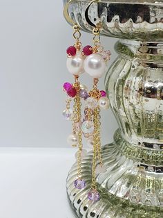 Gemstone dangle earrings Gemstone Chandelier Earrings.  Total length 9cm Beautiful Handcrafted,  Wire wrapped earrings. With Freshwater pearls. Amethyst. Ruby, Rose Quartz and Czech glass Crystal Beads. And Gold Plated findings and ear hooks.  One of a kind. In colours of pinks. Purples  reds. Ruby Metaphysical Properties It has been associated with improved energy and concentration, creativity, loyalty, honor and compassion. Ruby is thought to be protective of home possessions and family. Ruby Crystal Chandelier Earrings As A Gift, Crystal Dangle Earrings As Gift, Long Drop Chandelier Earrings With Dangling Beads For Gift, Pink Pearl Drop Chandelier Earrings, White Wire Wrapped Dangle Crystal Earrings, Dangle Pearl Earrings With Dangling Beads For Party, Elegant Pink Chandelier Earrings With Dangling Beads, Dangle Wire Wrapped Crystal Earrings For Party, Dangle Crystal Earrings With Pearl Drop