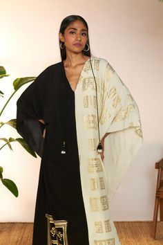 Introducing a chic mid-length kaftan, a perfect fusion of style and comfort. Crafted with a classic v-neckline and adorned with a contrasting border detail along the neckline and sleeve hem, this kaftan exudes understated elegance. The black contrast adds a sophisticated touch, while the mid-length design offers versatility for various occasions. Paired with a coordinating slip for added coverage and comfort, this kaftan is ideal for both casual outings and special events, ensuring you look effo Elegant V-neck Kurta For Festive Occasions, Elegant V-neck Kaftan For Festive Occasions, Festive V-neck Kaftan, Festive Silk V-neck Dress, Elegant Silk Tunic For Eid, Elegant Silk Tunic For Festive Occasions, Elegant Festive Silk Tunic, Elegant White V-neck Kaftan, Summer Festive V-neck Kaftan