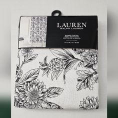 the packaging for lauren's bedding is shown with black and white flowers on it