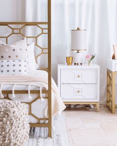 a bedroom with white and gold decor