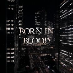 the words'born in blood'are lit up over a cityscape at night