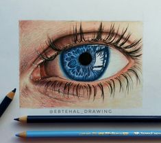 a pencil drawing of an eye with blue iris