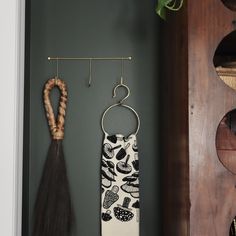 an umbrella hanging on a wall next to a potted plant