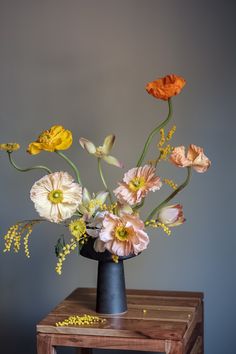 an arrangement of flowers in a black vase