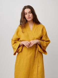 "ATHENA is a robe style linen wrap dress. DETAILS - Self tie belt with no closure or belt loops - Above the the knee length - Robe style - Dropped shoulders - Long sleeves - Side seam pockets - 100% midweight European linen fabric - Cut and sewn to order just for you in our studio COLOR - Mustard, you can also choose other colors above - Fabric samples are available here https://www.etsy.com/listing/586569696/linen-fabric-samples SIZING & FIT - Very oversized fit - Model is 5'6\" / 172 cm and wearing a size M CARE FOR LINEN - Machine wash up to 30ºC/86ºF gentle cycle - Lay flat to dry or tumble dry low - Warm iron if needed - Do not bleach SIZE GUIDE Body measurements guide in inches Size XS to fit bust 30-32\", waist 24-26\" and hips 31-33\" Size S to fit bust 34-36\", waist 28-30\" and h Belted Linen Wrap Dress, Spring Wrap Robe With Belt, Linen Gown, Dress With Kimono, Linen Summer Dress, Kimono Gown, Linen Wrap Dress, Linen Kimono, Linen Crop Top