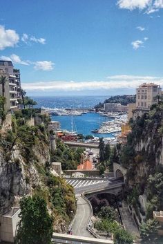 an aerial view of a city with boats in the water and cliffs on both sides