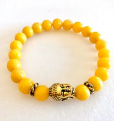 "Darling sunny yellow jade stretch bracelet with gold Buddha bead focal. Mashan jade gemstones are smooth polished 8mm rounds dyed a bright sunshine yellow color. Beautiful Buddha head focal bead is 10 x 14mm gold plated pewter made by Tierracast in the USA. Bracelet is made to order on professional stretch elastic. When selecting length please add 3/4\" to 1\" to your actual wrist measurement for a comfortable fit." Picasso Flowers, Usa Bracelet, Beautiful Buddha, Gold Buddha, Bright Sunshine, Buddha Bracelets, Buddha Beads, Sweet Earrings, Yellow Jade