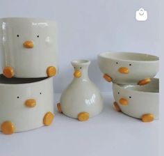 three white bowls with orange ducks on them