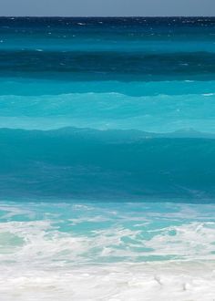 a man riding a surfboard on top of a wave in the ocean