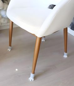 a white chair sitting on top of a hard wood floor