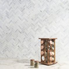 an old wooden box with spices and salt in it sitting on a marble countertop