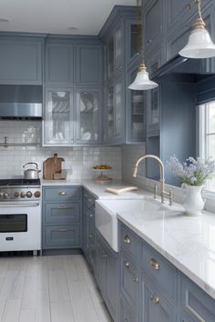 a kitchen with blue cabinets and white counter tops