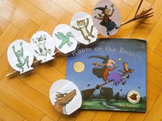 several children's books are laying on the floor next to some stickers that say room on the broom