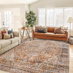 a living room filled with furniture and a rug