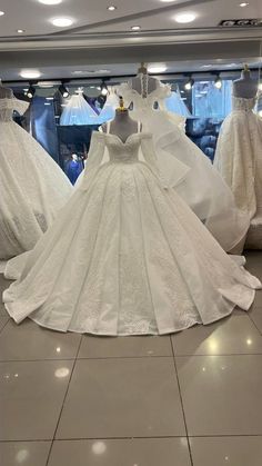 wedding dresses on display in a store window